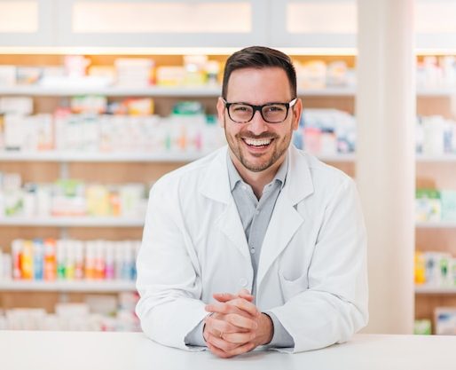 portrait-cheerful-handsome-pharmacist-leaning-counter-drugstore_looking for distributors